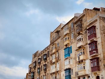 Low angle view of building against cloudy sky