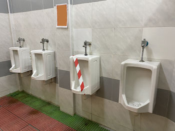 A tape is attached to an urinal pot to prevent usage for social distancing