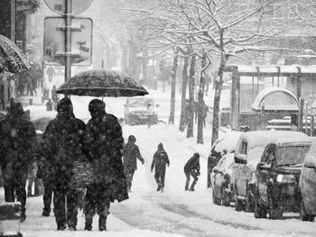 People walking on snow covered road during winter