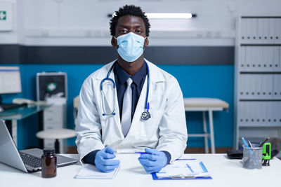 Female doctor examining chemical in laboratory