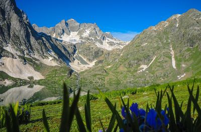 Scenic view of mountains against clear blue sky