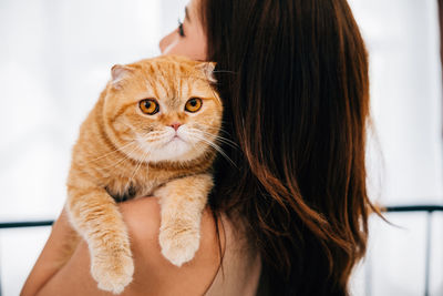 Close-up of woman with cat