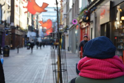 Rear view of man wearing warm clothing in city