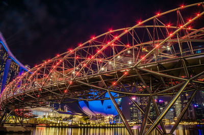 Low angle view of illuminated ferris wheel at night