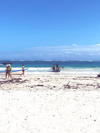 People on beach against sky