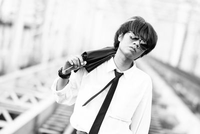 Portrait of young man in sunglasses standing outdoors