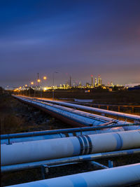 Pipeline outside city at dusk