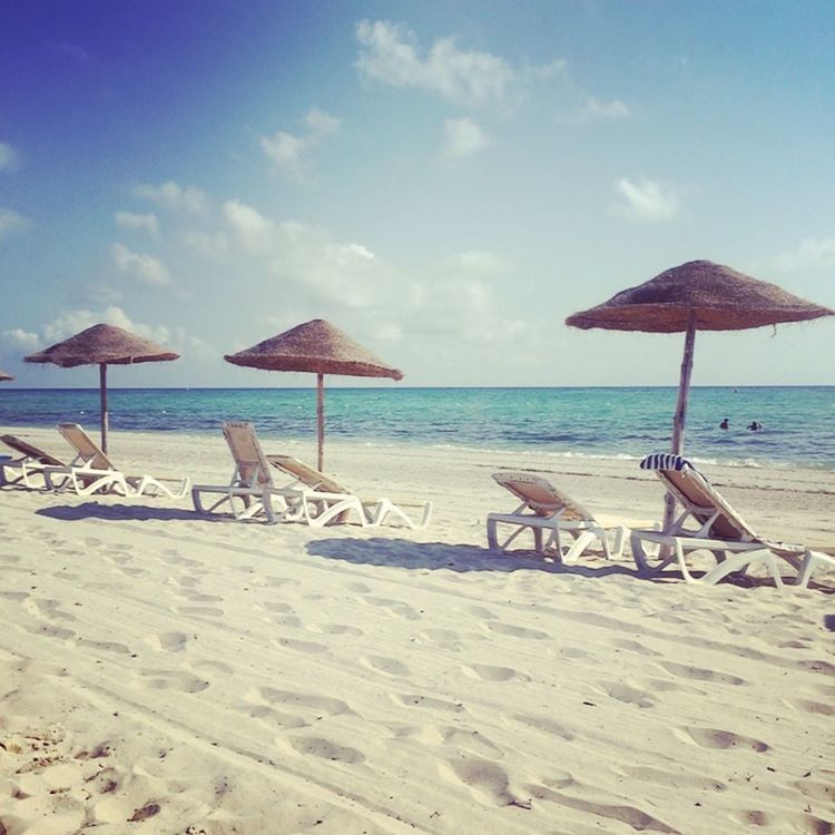 beach, sea, horizon over water, sand, shore, water, sky, tranquil scene, tranquility, scenics, beauty in nature, beach umbrella, nature, vacations, absence, lounge chair, sunlight, parasol, chair, sunshade