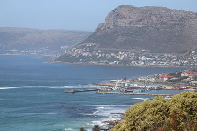 Scenic view of sea and mountains against sky
