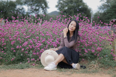 Young woman sitting on field