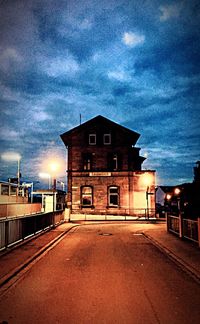 View of illuminated building against cloudy sky