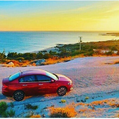 sea, transportation, horizon over water, sunset, sky, water, scenics, tranquil scene, tranquility, beauty in nature, mode of transport, beach, orange color, nature, land vehicle, idyllic, yellow, car, tree, blue