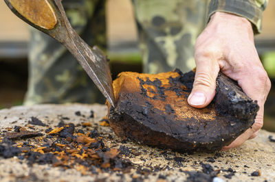 Close-up of man working on metal