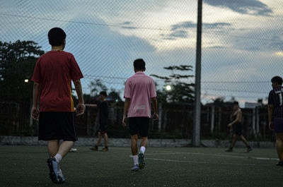 Rear view of people playing soccer