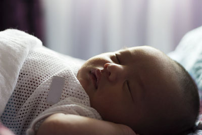 Close-up of baby sleeping at home