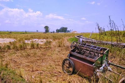 Abandoned truck on agricultural field against sky