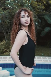 Portrait of young woman standing outdoors