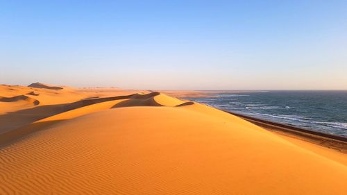 Scenic view of sea against clear sky during sunset