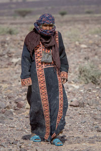 Midsection of woman standing on field