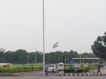 American flag on road against clear sky