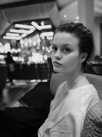 Portrait of young woman sitting outdoors