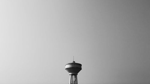 Low angle view of communications tower against sky