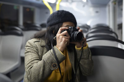 Woman taking photos in a public transportation