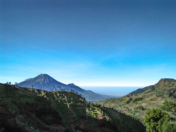 Scenic view of mountains against clear blue sky