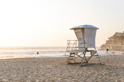 Lifeguard hut on beach against clear sky