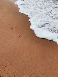 High angle view of surf on beach