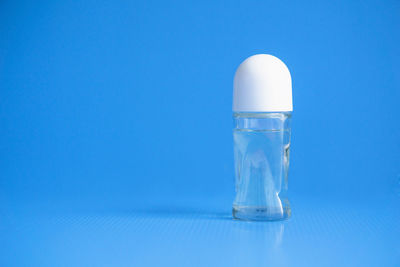 Close-up of light bulb on table against blue background