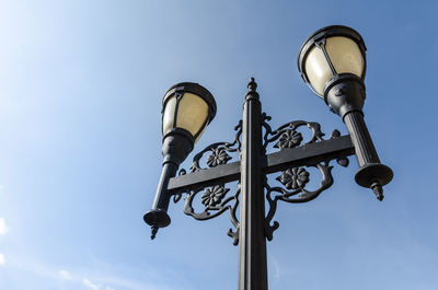 Low angle view of illuminated street light against sky