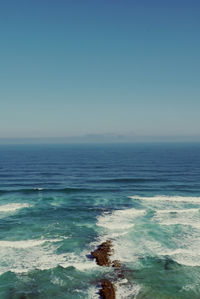 Scenic view of sea against clear blue sky