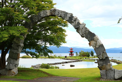 Built structure by trees against sky