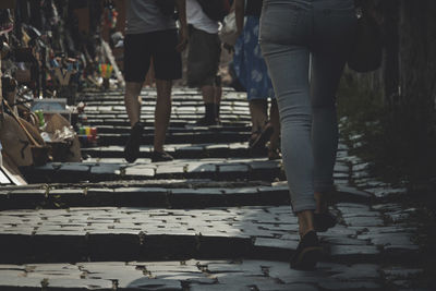 Low section of man walking on tiled floor