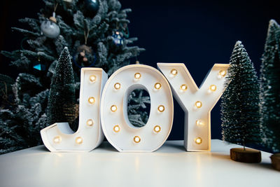 Close-up of illuminated christmas tree on table