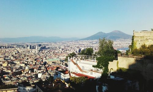 High angle view of town against clear blue sky