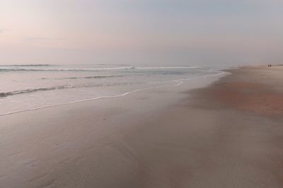 Scenic view of beach against sky during sunset