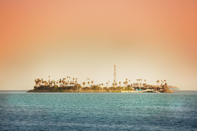 Scenic view of sea against clear sky during sunset