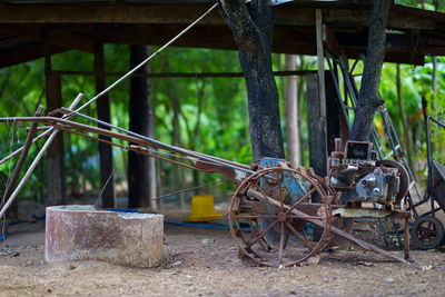 Old rusty machine on field