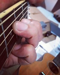 Close-up of hands playing guitar