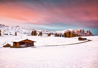 Snow covered buildings on mountain against sky