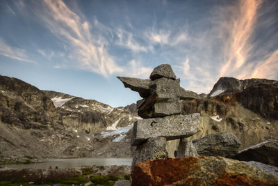 Sculpture on rock against sky