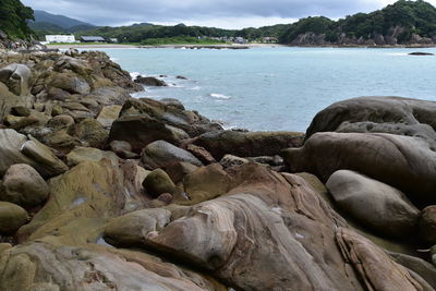 Rocks on beach against sky
