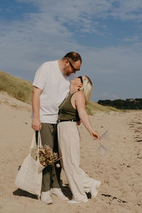 Side view of woman standing at beach