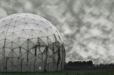 Built structure on field against sky