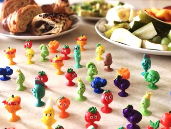 High angle view of colorful toys by food on table