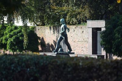 Statue against trees in park