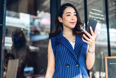 Young woman using smart phone