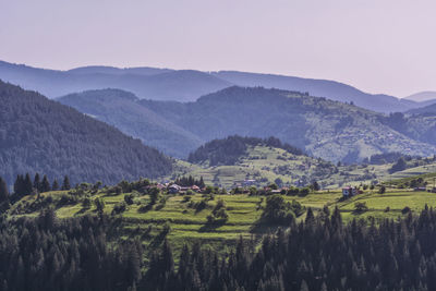 Scenic view of agricultural field and mountains against sky